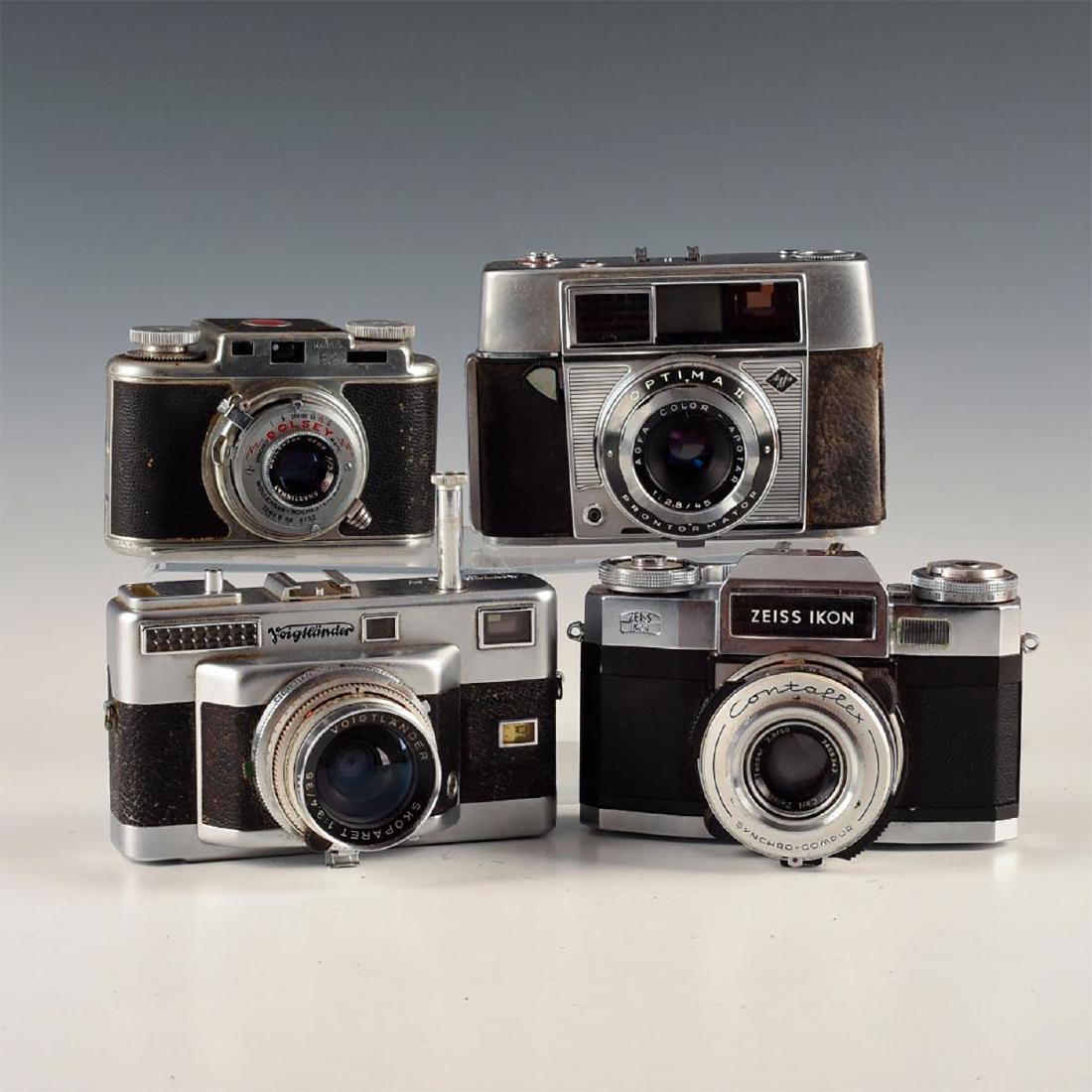 LOT OF 4 ESOTERIC VINTAGE RANGEFINDER CAMERAS: Voightlander, Bolsey, Agfa, and Zeiss Ikon- replete with chrome. All but Voightlander Vitessa T have leather cases. Vitessa features rapid-fire advance plunger; Agfa Optima II and Zeiss Contaflex Flas