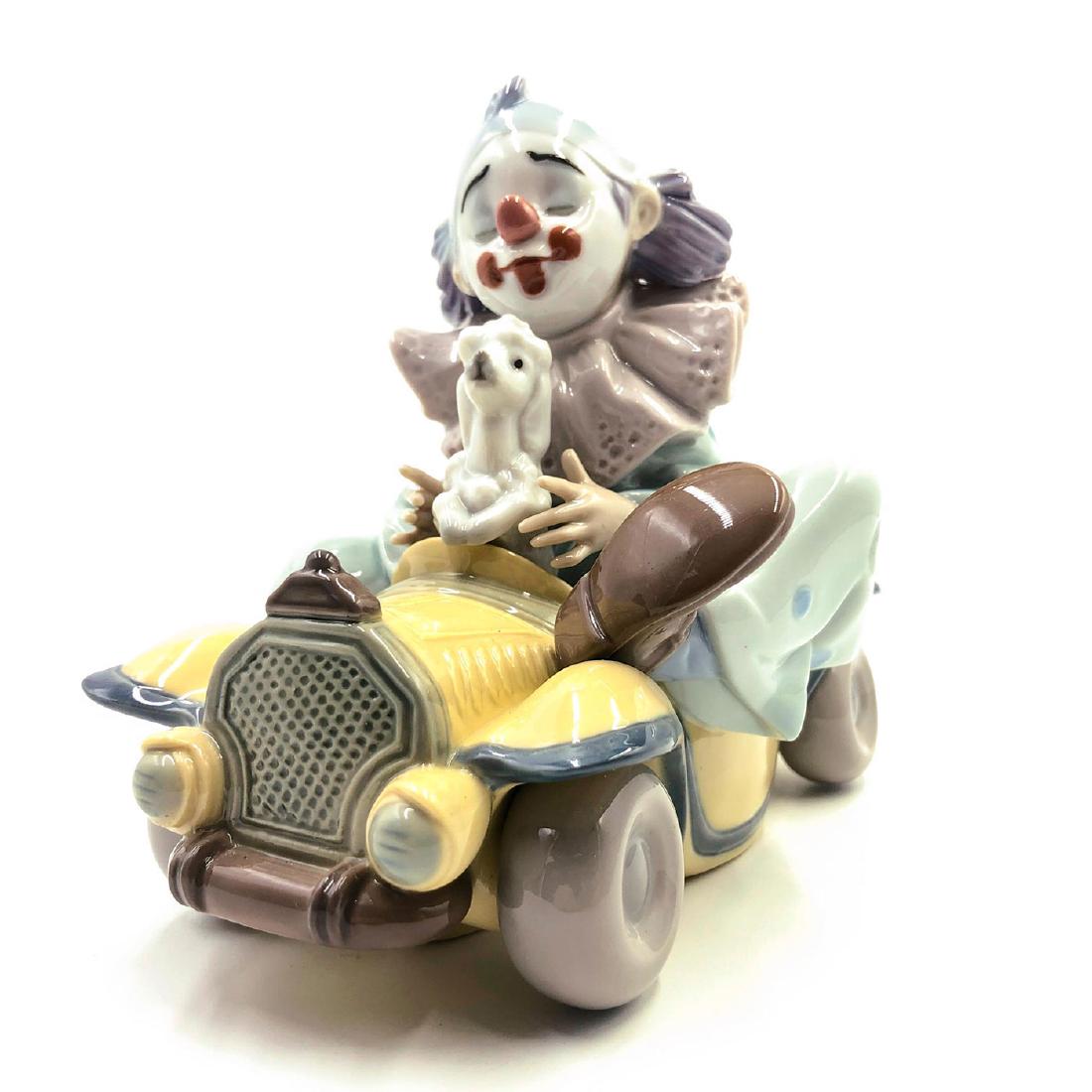 LLADRO FIGURINE TRIP TO THE CIRCUS: Clown driving a car with a dog at high speed - Lladro number 01008136. AUTOS LOCOS. Artist: Francisco Polope Issued: 2005 Dimensions: 9.64"H Manufacturer: Lladro Country of Origin: Spain