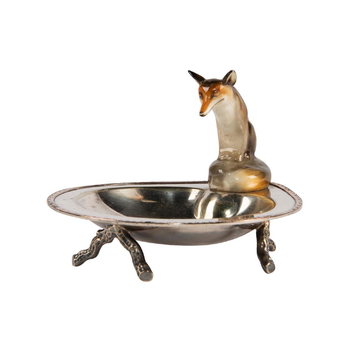 ROYAL DOULTON STERLING SILVER TRAY FOX SEATED: Brown fox seated on a sterling silver tray. Royal Doulton Fox Seated HN147C-1 on a small sterling silver with three small branch-like legs. Artist: Unknown Issued: c.1920's Dimensions: 4"H Manufacture