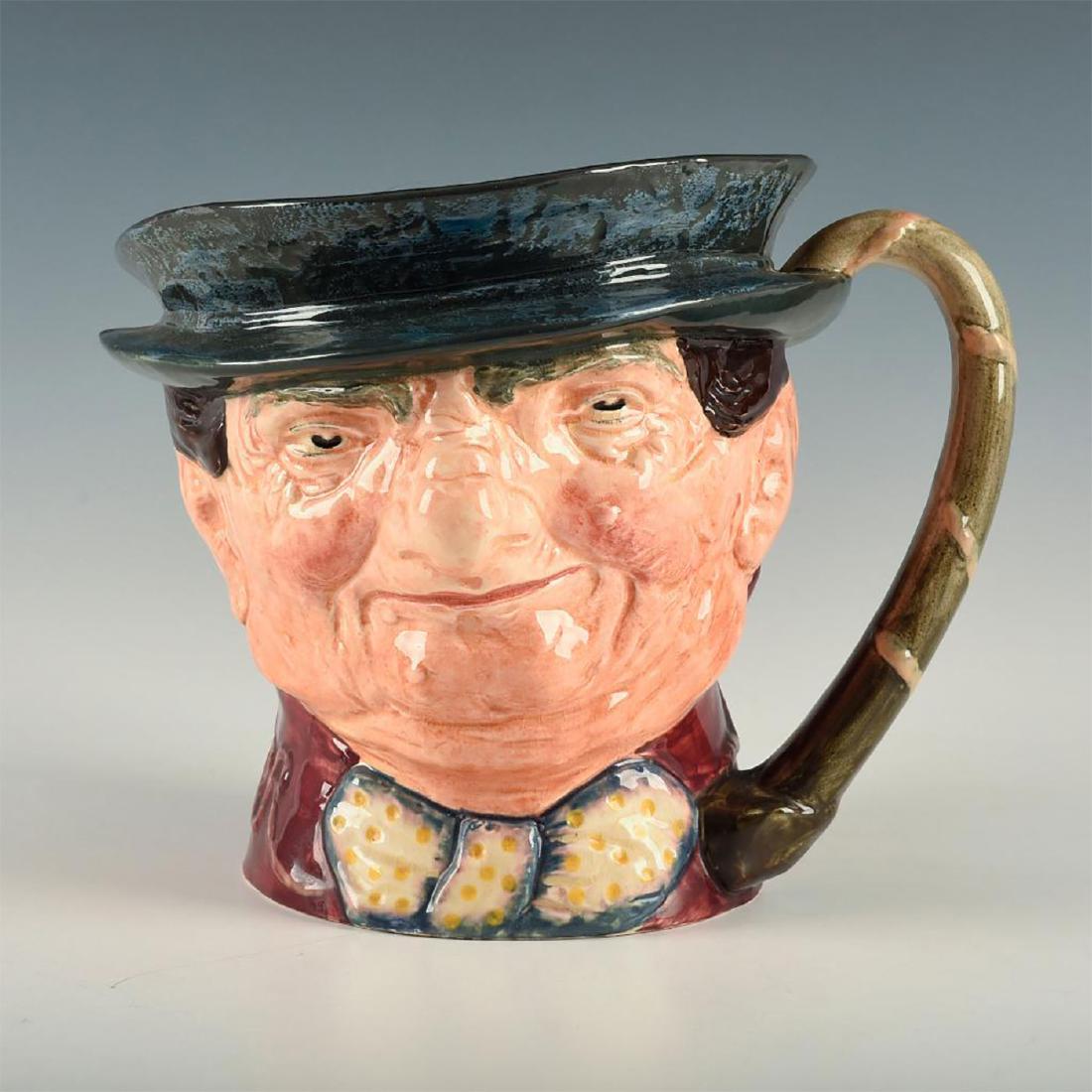 ROYAL DOULTON MUSICAL JUG TONY WELLER: Dark grey hat; maroon coat; grey-white bow with yellow spots. Character from Charles Dickens' series. Working musical jug that has a genuine Thorens Swiss Movement that plays "Come Landlord Fill the F