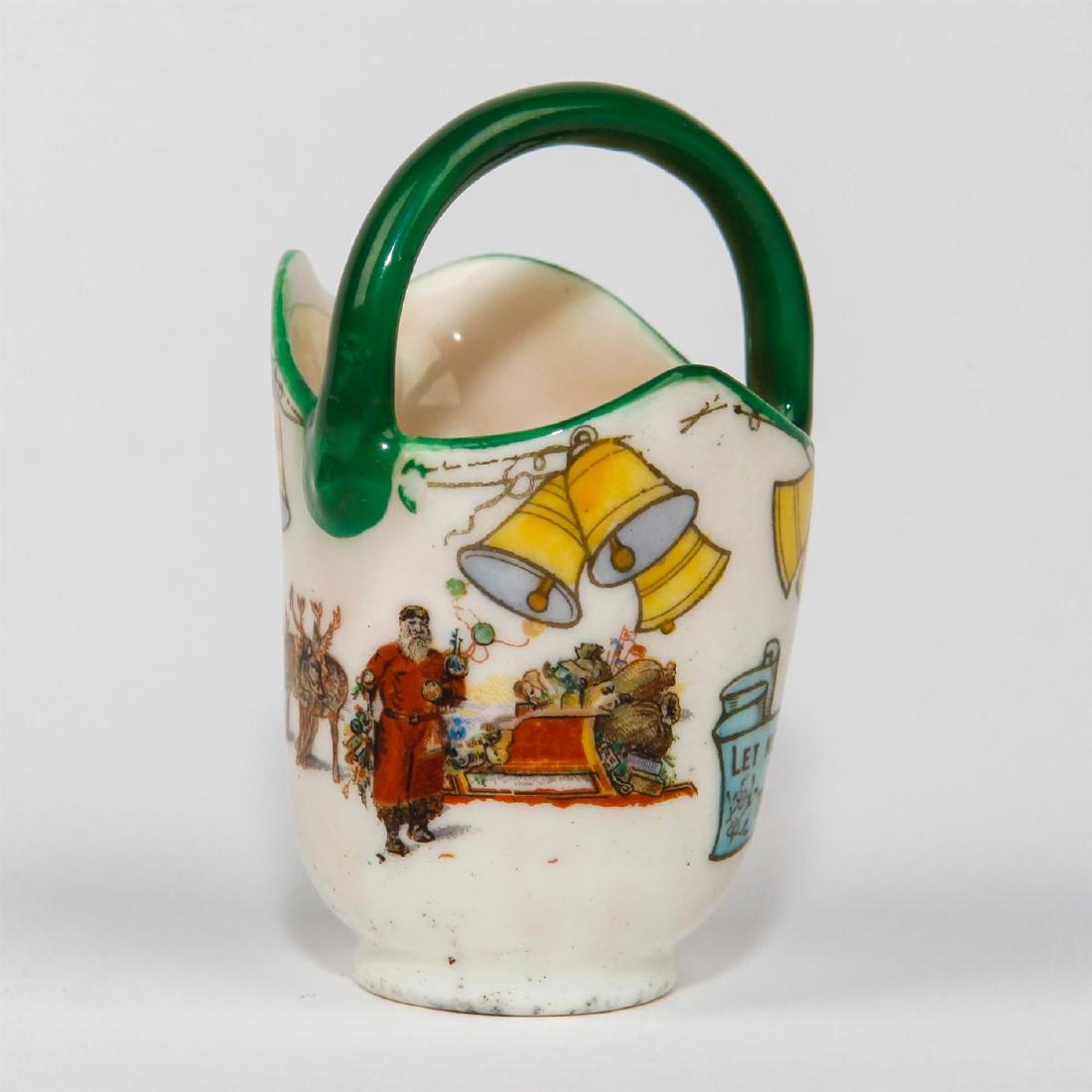 ROYAL DOULTON CHRISTMAS MINIATURE VASE: Rare shape in the Doulton Christmas Santa Claus series. With Santa Claus at his sleigh, holding balloons, and inscribed on the side of bucket " Let Not the Hearts Whose Sorry Cannot Call This Christma