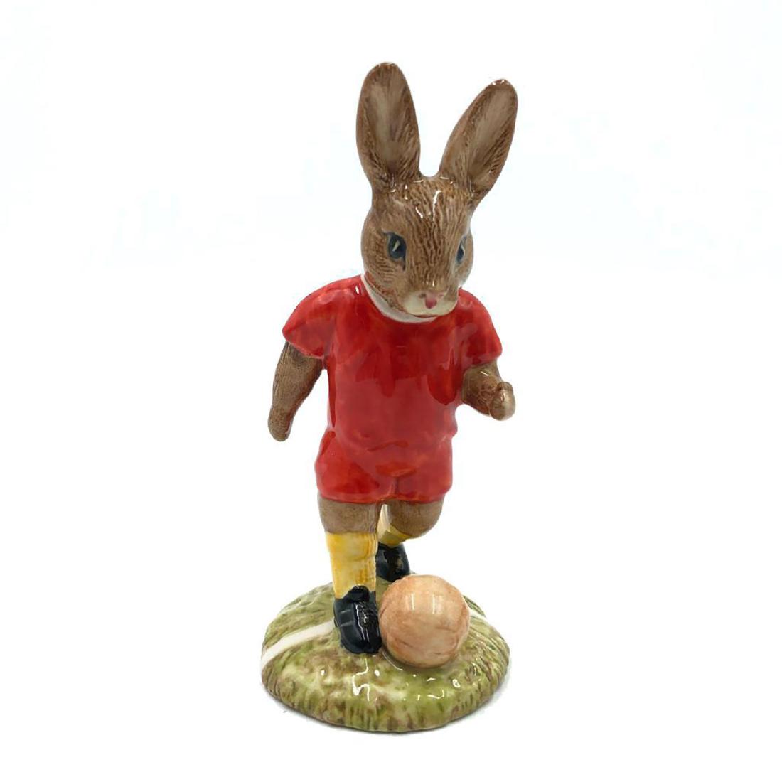 ROYAL DOULTON FOOTBALLER BUNNYKINS DB119: Bunny dressed as a Footballer. From Footballer Series. Hand painted red uniform. Artist: Denise Andrews and Warren Platt Issued: 1991 Dimensions: 4.5"H Edition Size: 250 Manufacturer: Royal Doulton Co