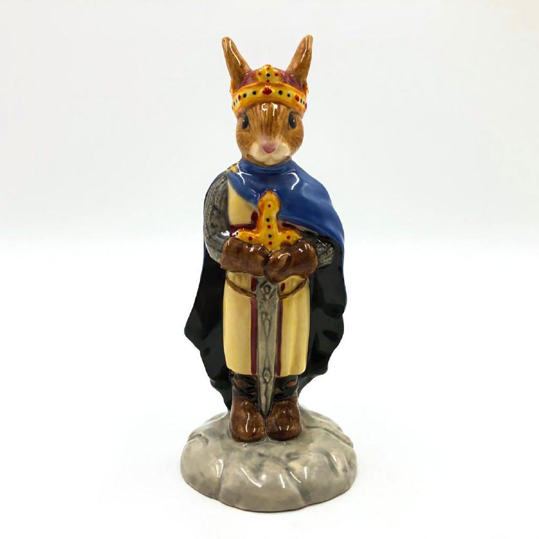 ROYAL DOULTON KING ARTHUR BUNNYKINS DB304: Bunny as King Arthur from Arthurian Legends Collection. Hand painted royal blue, cream, red, grey and orange. Artist: Unknown Issued: 2004 Dimensions: 4.75"H Manufacturer: Royal Doulton Country of Ori