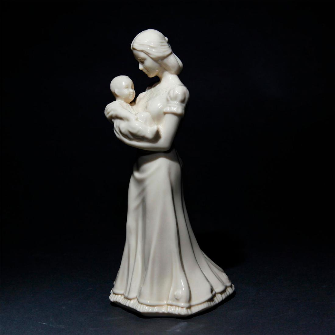 LENOX FIGURINE QUIET TIME: Porcelain figurine of a mother cradling her baby. Figurine is cream colored. Marked to the underside Lenox China Jewels Collection. Issued: 1994 Dimensions: 8.75"H Manufacturer: Lenox Country of Origi