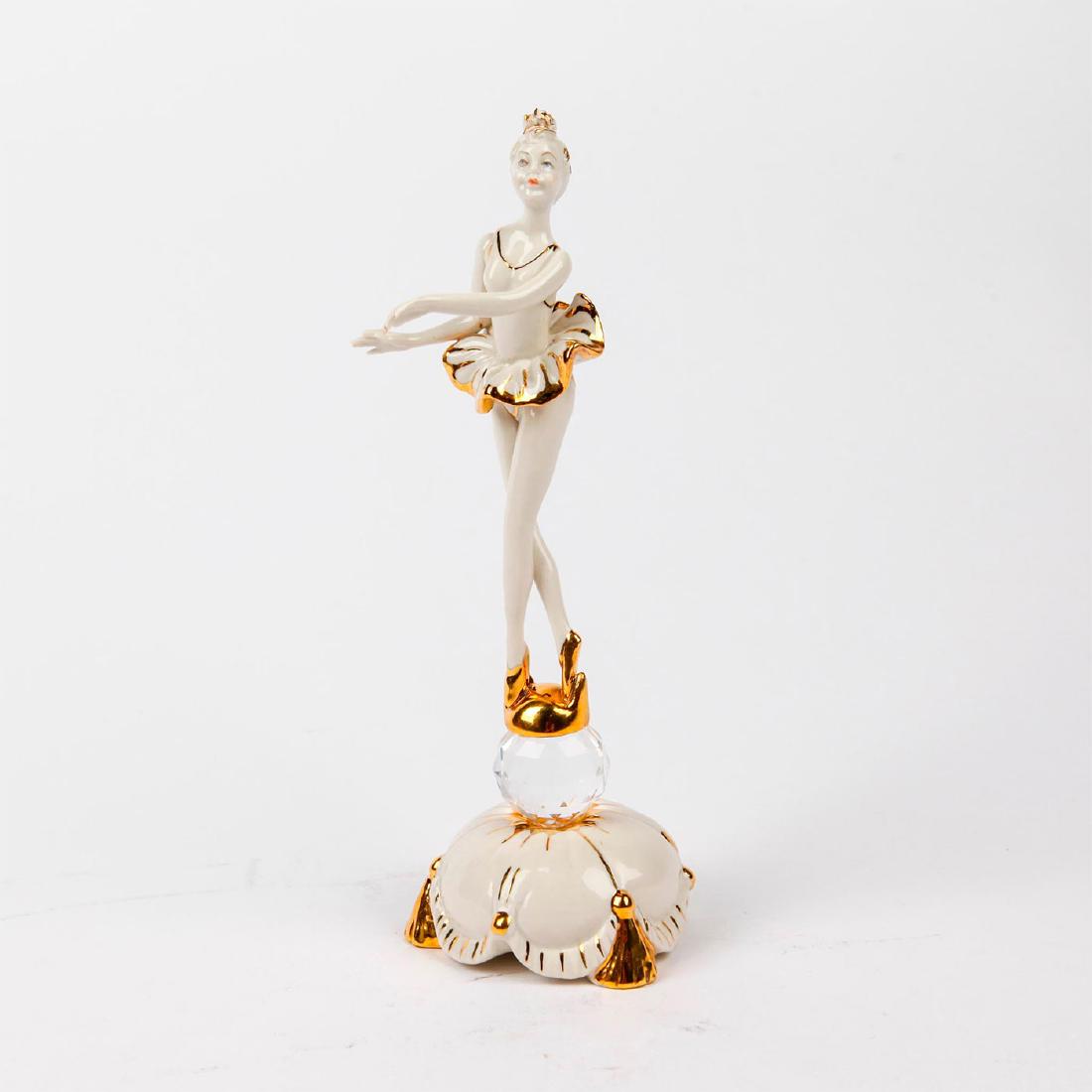 CAPODIMONTE & SWAROVSKI FIGURINE DANCING BALLERINA: Figurine of a ballerina standing on a circular crystal swarovski. Handpainted and accented with gilt. Capodimonte backstamp. Artist: Cesare Villari Issued: 20th Century Dimensions: 8.75"H Manufacturer