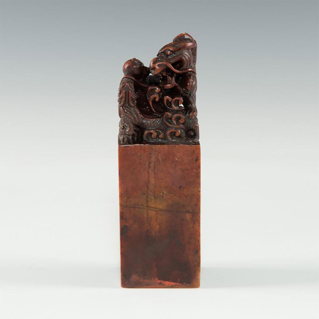 CARVED CHINESE SOAPSTONE SEAL STAMP DRAGON FIGURE: Stone carving in a shape of dragon holding a ball. Dimensions: 4"H Country of Origin: China