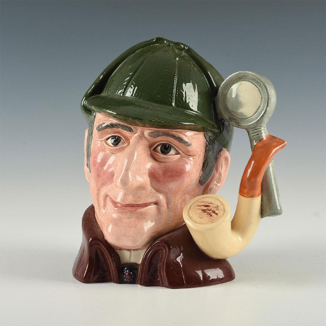 ROYAL DOULTON LARGE CHARACTER JUG, THE SLEUTH D 6631: Pipe and magnifying glass handle, dark green Sherlock Holmes hat. Modeled as literature's greatest sleuth, Sherlock Holmes, who first appeared in print in 1887, the conception of British writer and ph