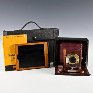 COMPLETE SYSTEM, SEROCO JUNIOR FOLDING CAMERA: Features lacquered wooden parts with Wollensak shutter. Includes camera case, 4x5 plateholder, partially opened Kodak Super-XX film pack.ï¿½Wollensak junior shutter with time, bulb and instant