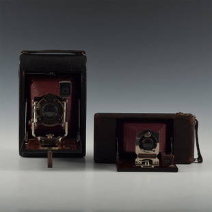 PAIR RICHLY APPOINTED WOOD AND CORDOVAN LEATHER CAMERAS: Antique Kodak, Ansco bellows cameras decked in mahogany/leather. Kodak No. 4 Folding Pocket Model B featuring pneumatic shutter activators, vertical adjust, and fine gold-script instructions on the