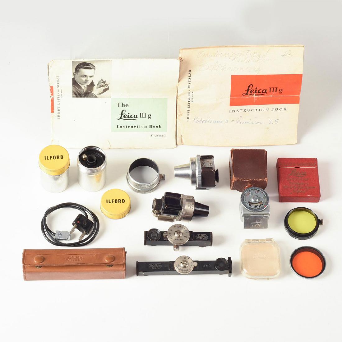 LOT OF 16 LEITZ AND KINOX ACCESSORIES, RANGEFINDERS: Leica metal film rolls, adjustable view and rangefinders, more. Up for auction is this lot of broadly assorted Leica accessories, which includes an English Leica IIIg quick-start and full instruction 