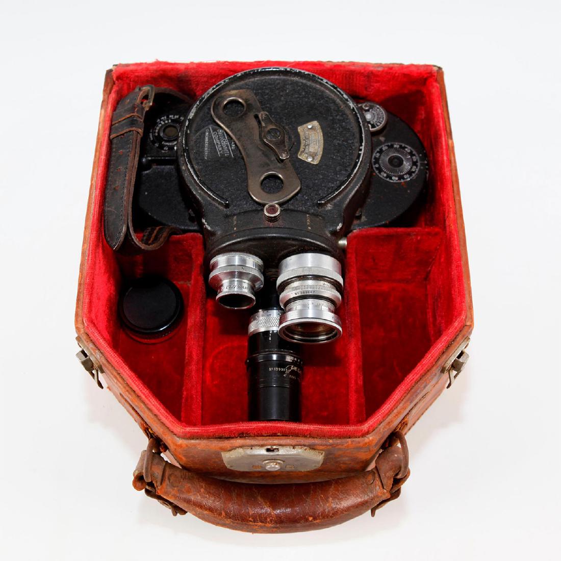 ANTIQUE BELL & HOWELL 16MM MOVIE CAMERA IN CASE: Running cine camera with 3 lenses on turret, strap, velvet case. Issued: 20th c. Dimensions: 11"L x 9"D x 5.5"H, in case Manufacturer: Bell & Howell Country of Origin: United States