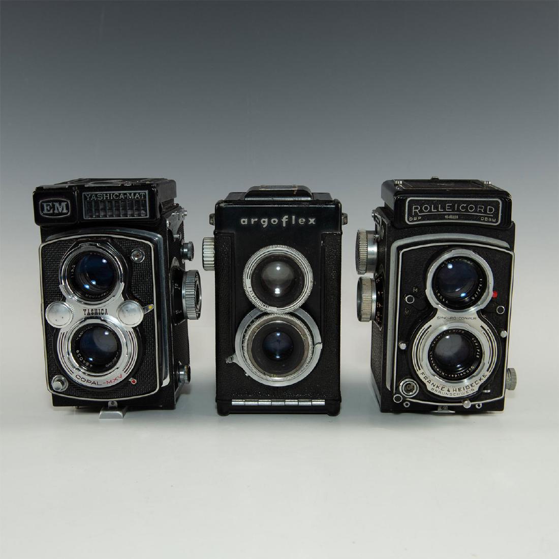 GROUP OF 3 TWIN LENS REFLEX ROLL FILM CAMERAS: Mid 20th century manufacture. Rollei, Yashi, Argus- decked in chrome and black leatherette. Each with two objective lenses, one for "picture taking," the other for the viewfinder. Manufactured by 1. R