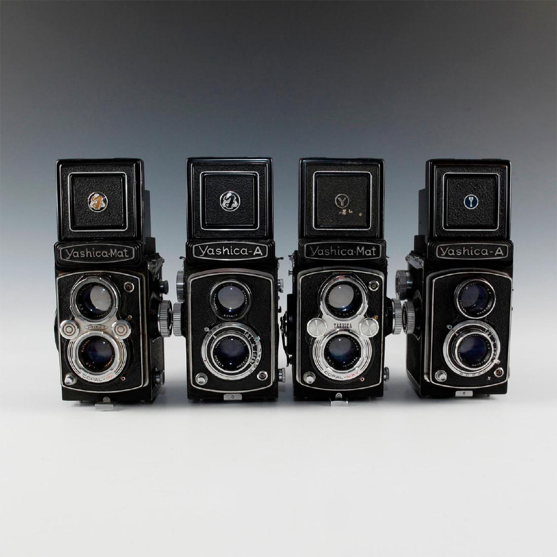 LOT OF 4 VINTAGE YASHICA TWIN LENS REFLEX FILM CAMERAS: Pair of As, Pair of Mats- 4 styles of Yashica emblems on hoods. Issued: 20th c. Dimensions: 4"L x 4"D x 8"H, open Manufacturer: Yashica Country of Origin: Japan