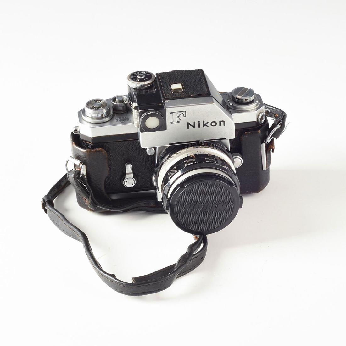 RARE NIKON F SLR CAMERA WITH PHOTOMIC T FINDER METER: Nikkor-H 2 F50mm auto lens, early electric meter, half case. Arguably one of the most iconic and revolutionary camera of its day, the Nikon F single-handedly catapulted Nikon from an excellent maker o