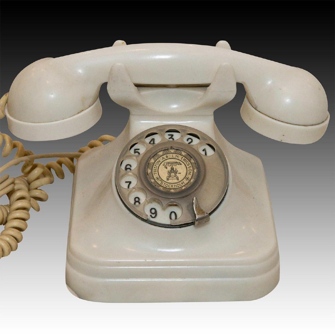 ERICSSON ROTARY WHITE BAKELITE TELEPHONE, CA. 1930: White Bakelite rotary telephone. Original coiled rubber cord. A vintage L.M. Ericsson white Bakelite rotary telephone stamped on the dial TELEFON A.B. L.M. ERICSSON STOCKHOLM. Original coiled rubber t