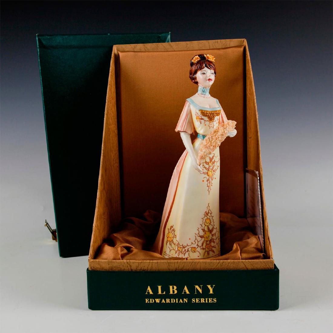 ALBANY FINE CHINA EDWARDIAN SERIES GEORGINA FIGURINE: Includes original box and certificate of authenticity. Figure of a woman wearing a yellow and blue floral designed dress holding a feather in hands. Fully stamped on base. Box measures 11.5"H x 6.25"W