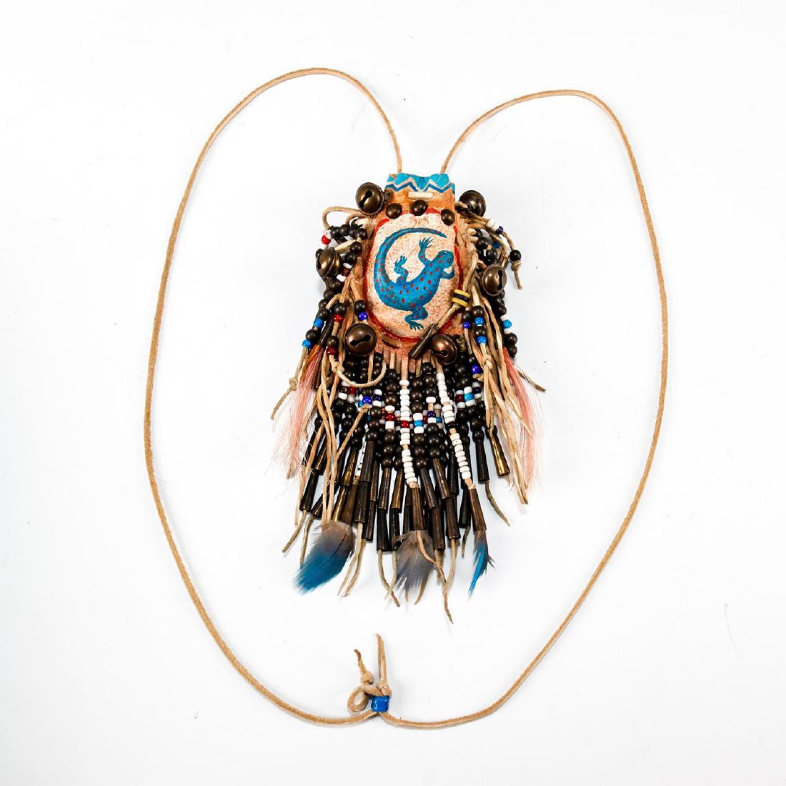 NATIVE AMERICAN HAND MADE TRIBAL MEDICINE BAG: Beaded leather bag, with hand painted central lizard. Colored beads, metal decorations. Leather tassels and ties, feathers. Issued: 20th c. Dimensions: 3.5"H x 2.5"W Country of Origin: United States