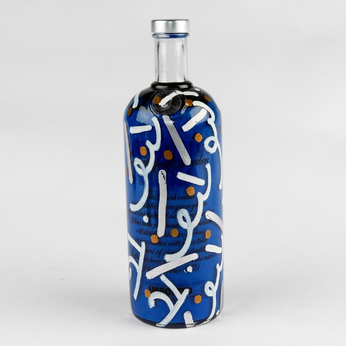 ORIGINAL ROMERO BRITTO ABSOLUT VODKA BOTTLE: Absolut Vodka bottle with silver highlights, filled with paint and painted on exterior by Brazilian pop artist Romero Britto (b. 1963), whose work combines elements of cubism, pop art and graffiti pai