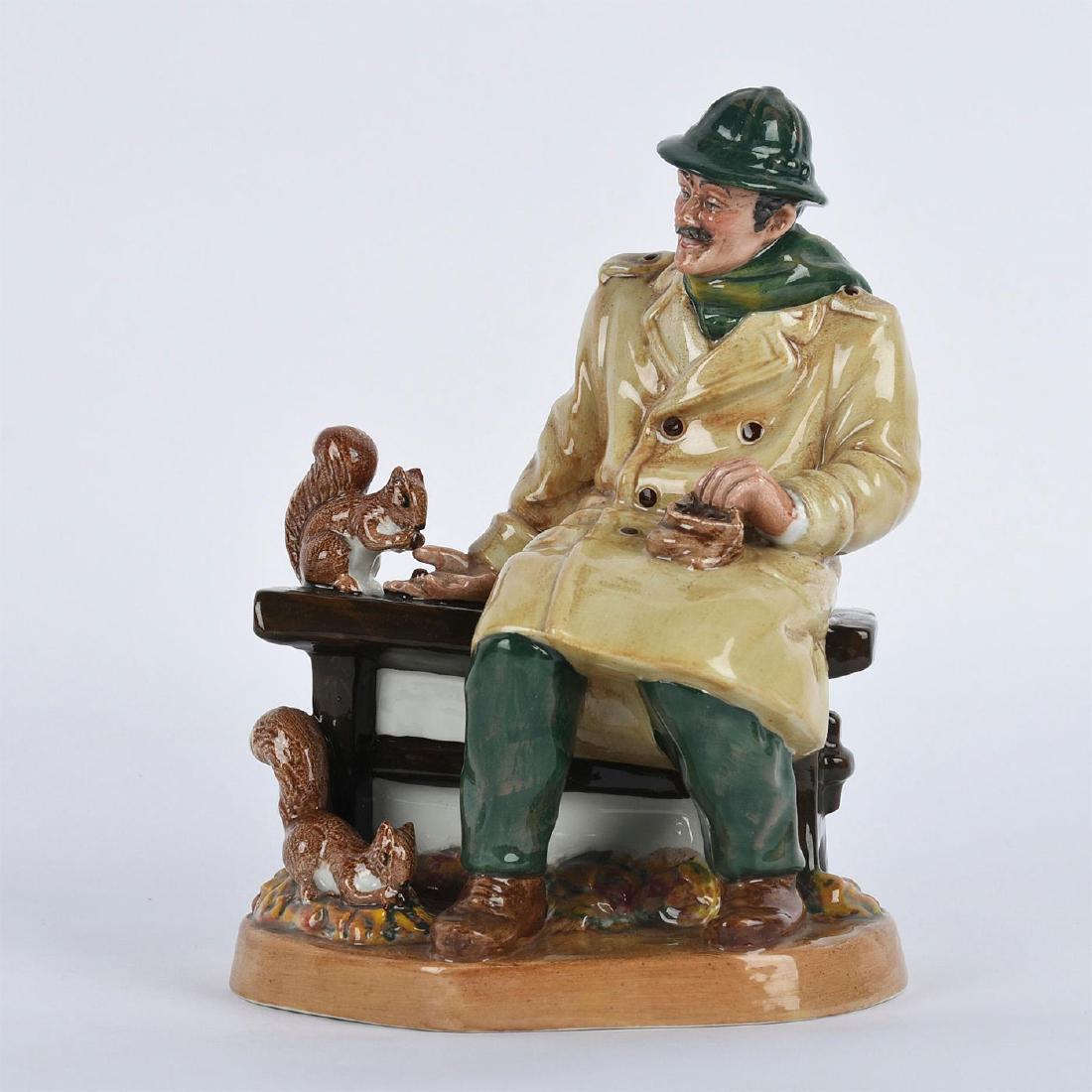 ROYAL DOULTON FIGURINE, LUNCHTIME HN2485: Handpainted, modeled as a man feeding nuts to squirrels. Royal Doulton backstamp. Artist: Mary Nicoll Issued: 1973-1981 Dimensions: 8"H Manufacturer: Royal Doulton Country of Origin: England