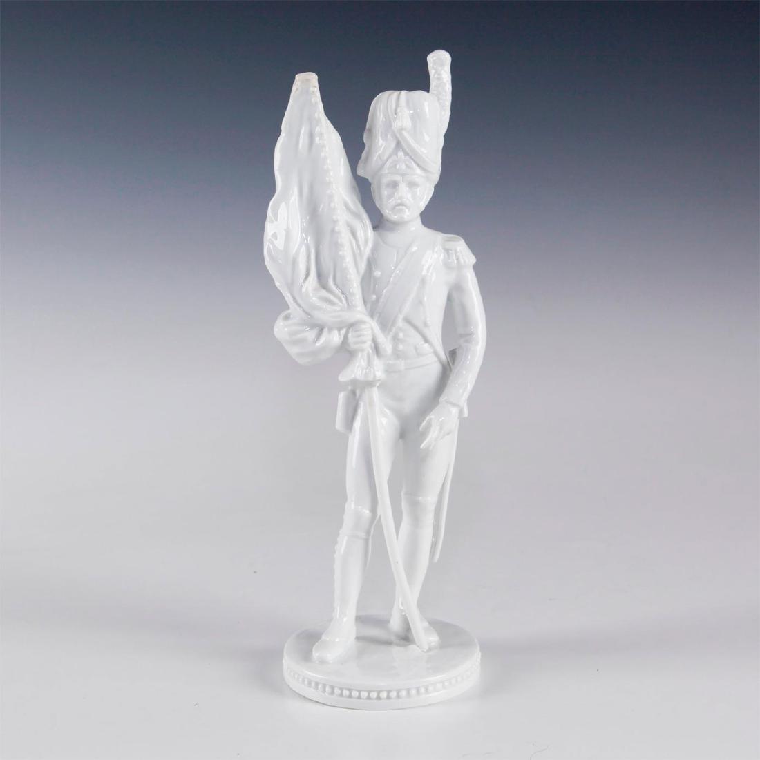 AK KAISER BOCHMANN FIGURE 'SOLDAT MIT FAHNE': Part of a series resembling personages of Napoleon Wars. Soldat Mit Fahne' translates to "Color Bearer Soldier". Bochmann's signature incised on the top of base. AK Kaiser backstamp. Artist: Gerhard B