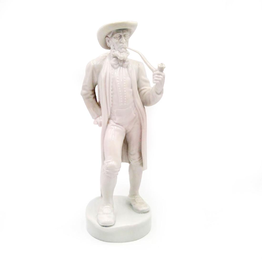 FURSTENBERG GERMAN PORCELAIN FIGURINE MAN AND PIPE: Furstenberg Figure of a Man with a Backpack and a Pipe. Issued: Early 20th c. Dimensions: 9.75"H x 3.5"D Country of Origin: Germany