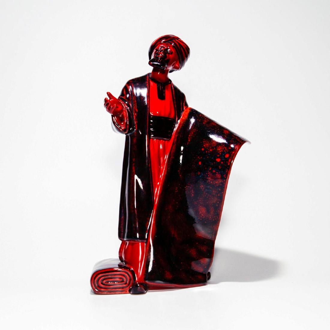 ROYAL DOULTON FLAMBE FIGURINE, CARPET SELLER HN2776: Doulton backstamp to bottom. Artist: William K. Harper Issued: 1990-1995 Dimensions: 9"H Manufacturer: Royal Doulton Country of Origin: England