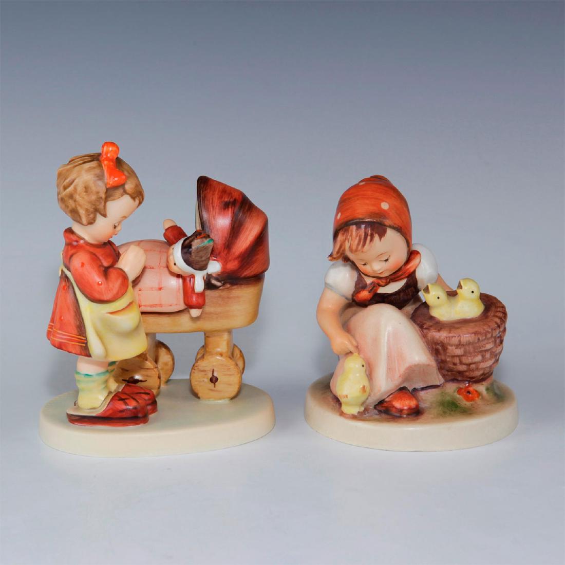 PAIR OF HUMMEL FIGURINES: Chick Girl (TMK2), Doll Mother (TMK6). Doll Mother is hand signed on bottom. Issued: 20th c. Dimensions: 4.5"H, tallest Manufacturer: Goebel Country of Origin: West Germany