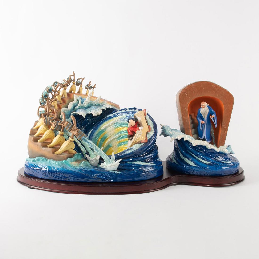 DISNEY SIGNATURE SERIES MAGICAL MAELSTROM: Ceramic sculpture of a scene from Fantasia. A two piece sculpture with wood base depicting Sorcerer Mickey, Sorcerer Yen Sid, and the broomsticks hauling buckets of water, from the Disney animated mov