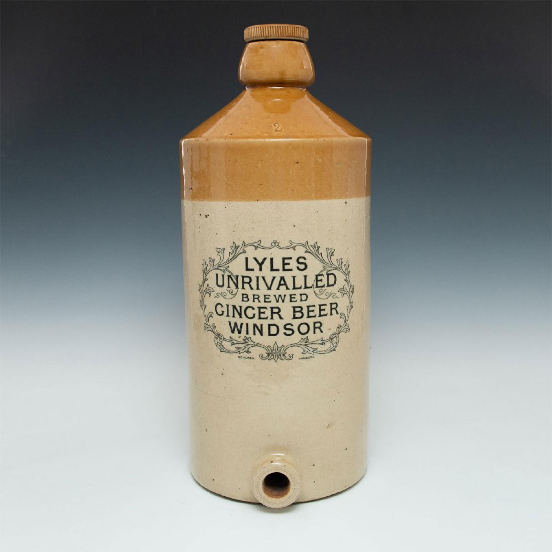 MONUMENTAL DOULTON LAMBETH GINGER BEER FLAGON: Stoneware vessel with screw top, salt glazed, hole for spigot. Marked on front LYLES UNRIVALLED BREWED GINGER BEER, WINDSOR, DOULTON LAMBETH. Impressed with a number 2. A once common sight in pubs and