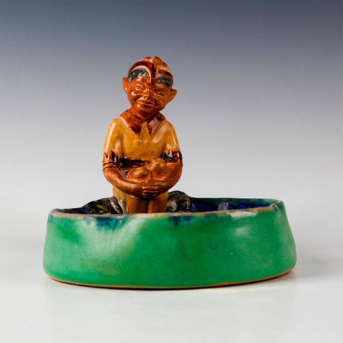 DOULTON LAMBETH ART DECO PIXIE ELF BIBELOT ASHTRAY: Decorative glazed stoneware in cobalt blue, green and brown. Stamped to base DOULTON LAMBETH ENGLAND with inscribed decorator mark. Artist: Harry Simeon Issued: c. 1927 Dimensions: 4.5"H x 5"W Manufac