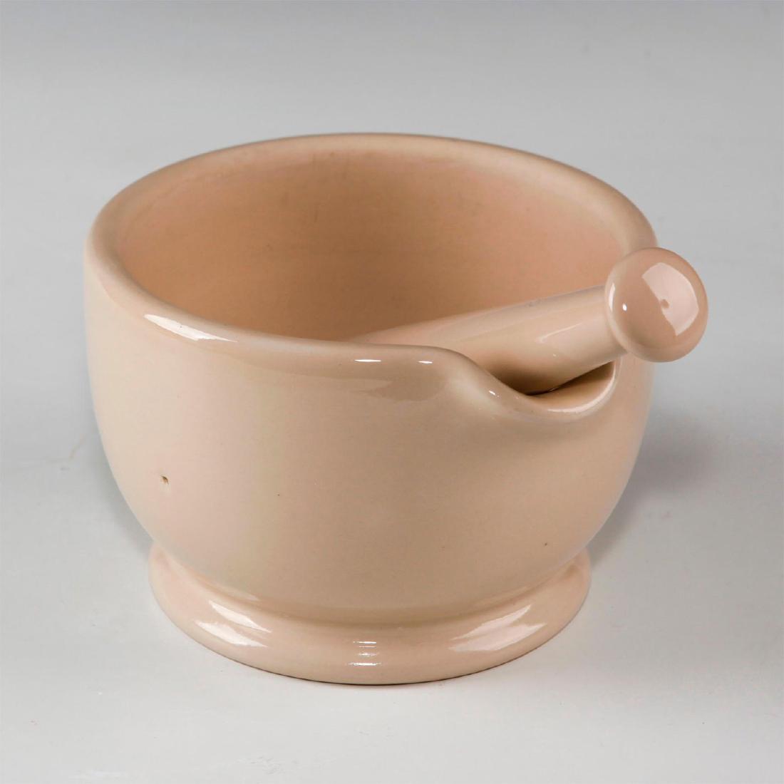 DOULTON LAMBETH STONEWARE APOTHECARY MORTAR AND PESTLE: Cream glazed enamel stoneware. Doulton Lambeth and number 5 mark. Issued: Early 20th century Dimensions: 4.75"H x 6.75"D Manufacturer: Doulton Lambeth Country of Origin: England