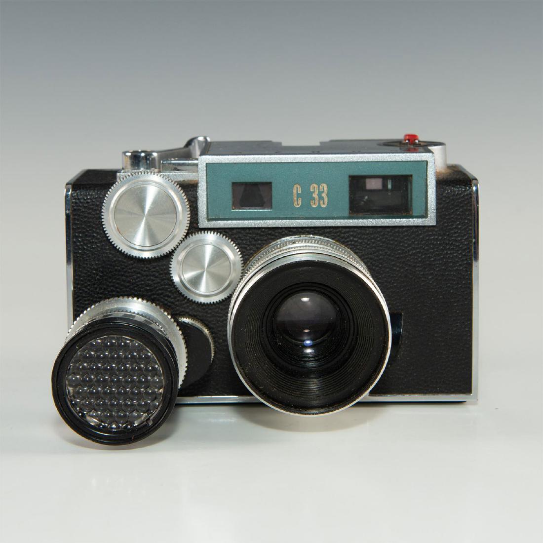 50'S ERA AMERICA RANGEFINDER ARGUS C33: Vintage Googie-style American camera in blue. Interchangeable lense. Leaf shutter with nine speeds. Issued: 1950s Dimensions: 3"H X 5.5"L X 3.75"D Manufacturer: ARGUS Country of Origin: USA
