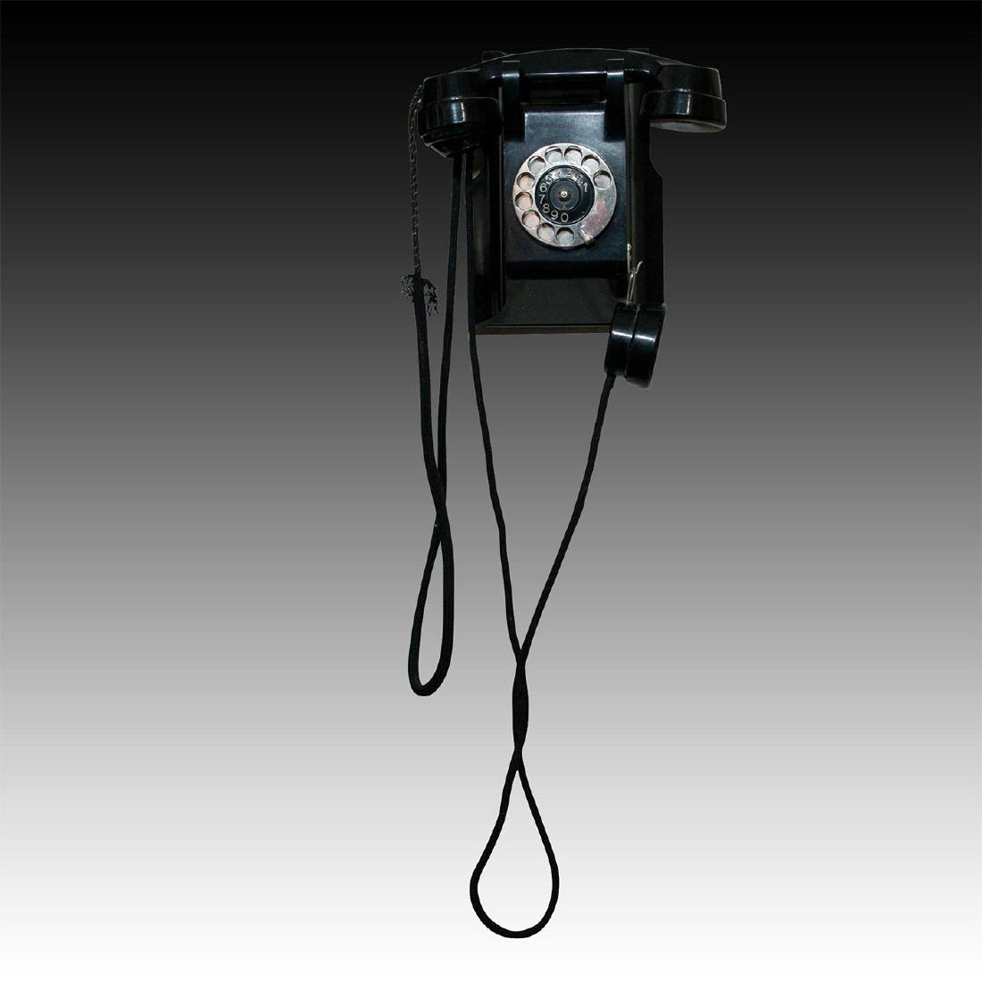 ERICSSON WALL MOUNTED TELEPHONE: Rotary dialer, striking jet black, sleek Mid Century design. Black Bakelite with evocative dialer and number. Faux spit cup mouthpiece. Stamped ROTTERDAM PLAATSELIJKE TELEFOONDIENST ("Municipal Teleph