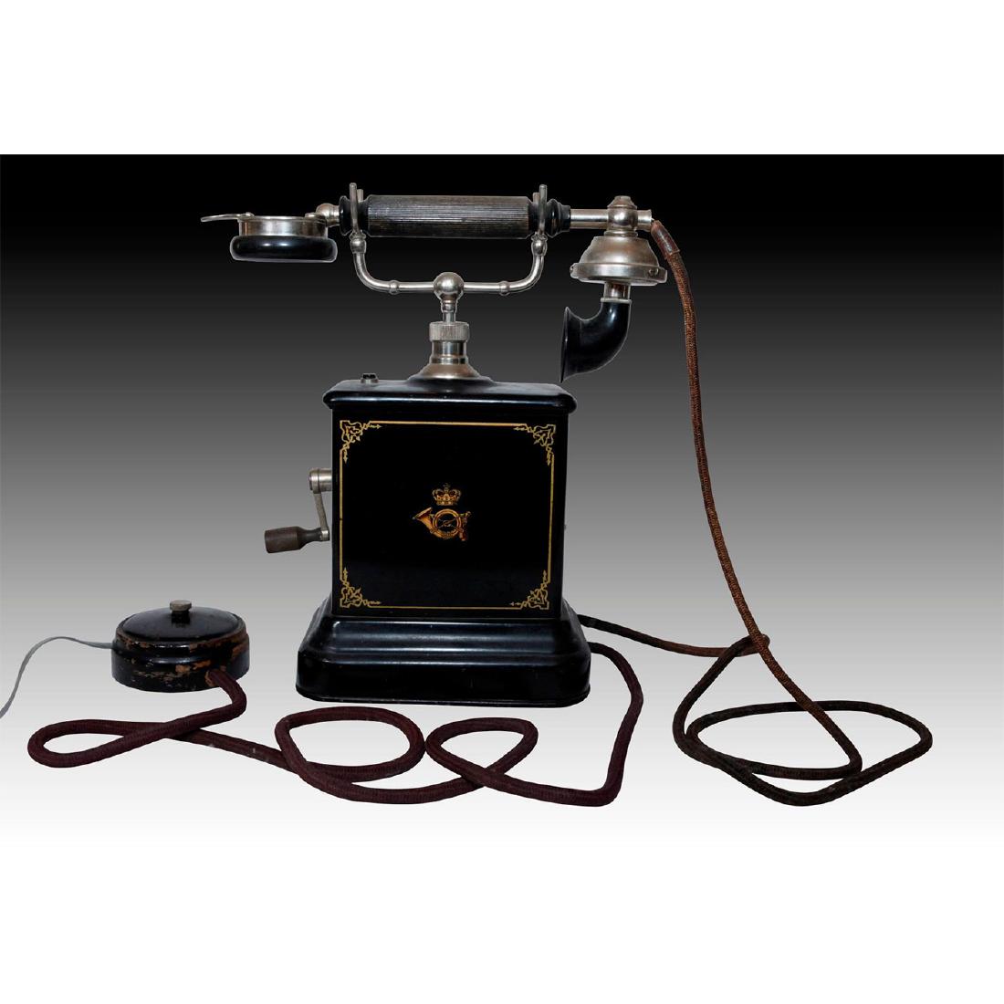KRISTIAN KIRK DANISH CRANK ROTARY TELEPHONE: Working crank with Bakelite handle. Grabaphone receiver. Produced by Kristian Kirks Telefonfabrikker. Manufactured on a black metal carriage with a hand painted decoration of crossed arrows imposed ov