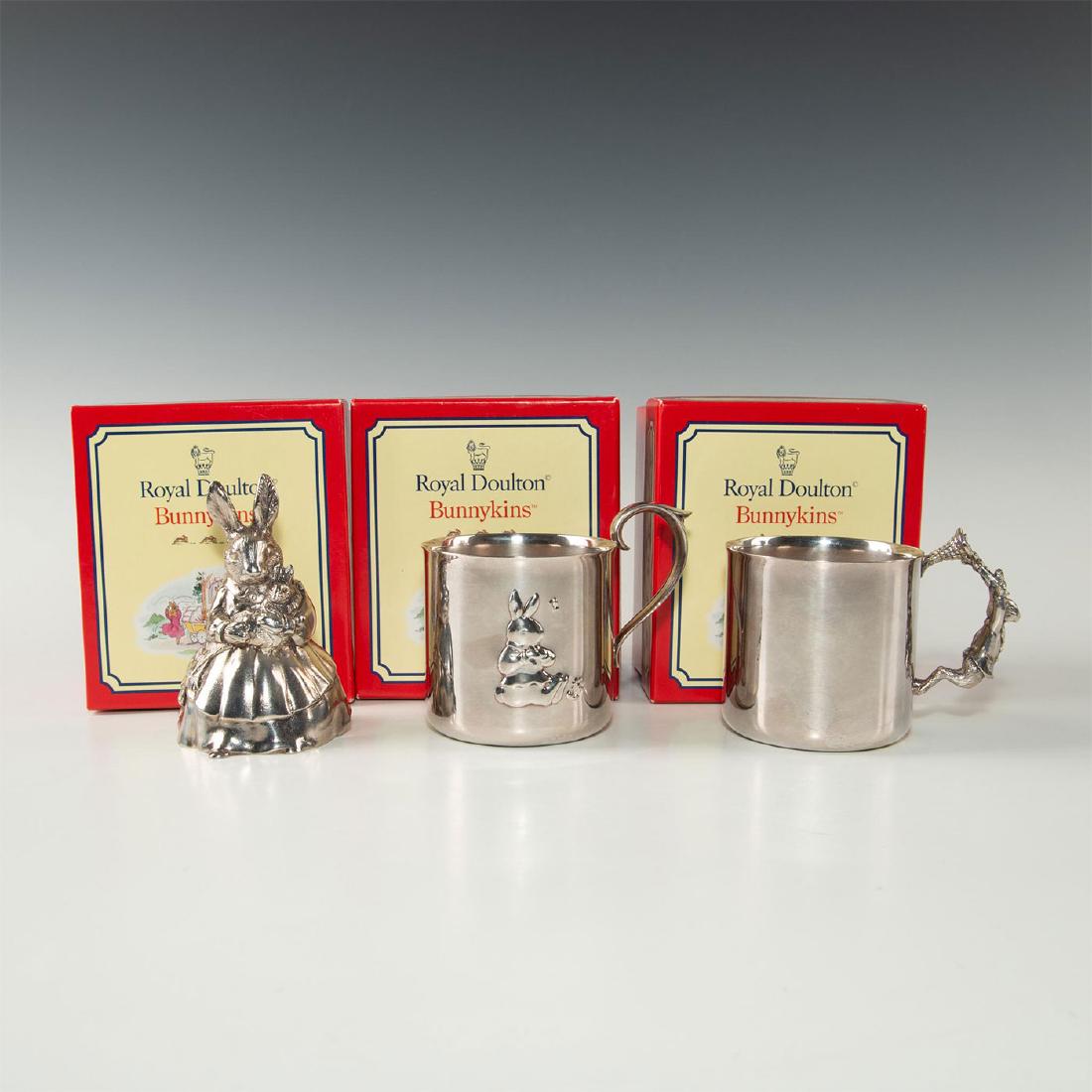 ROYAL DOULTON BUNNYKINS SILVERPLATE MUSIC BOX & CUPS: Special Edition in silver-plate, produced for Reed & Barton. Stamped to base ROYAL DOULTON and other marks. Original collectors box. Issued: 1998 Dimensions: 3.25"H, music box Manufacturer: Royal Doul