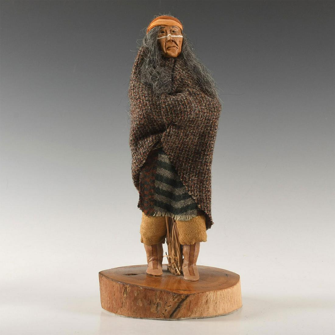 NATIVE AMERICAN CLAY PORTRAIT DOLL, ARTIST SIGNED: Made from organic clay with other naturalistic materials. Presented on a decorative wooden basis, a portrait doll by Choctaw Apache artist Linda Duran, artist signed DURAN rear side of base. Artist: L