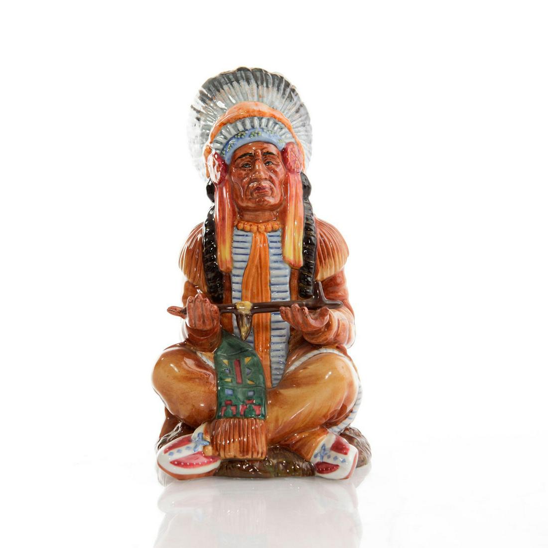 ROYAL DOULTON FIGURINE, THE CHIEF HN2892: Seated Native American chief in feathered headdress. Doulton backstamp. Artist: William K. Harper Issued: 1979-1988 Dimensions: 7.25"H Manufacturer: Royal Doulton Country of Origin: England