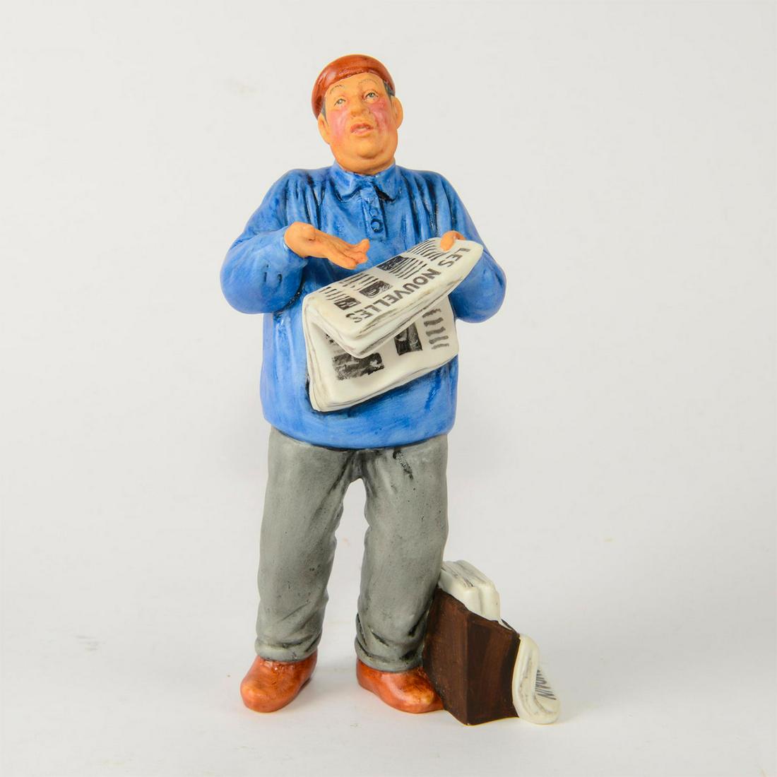 ROYAL DOULTON FIGURINE, THE PARISIAN HN2445: Man with French language newspapers. Stamped to bottom. Royal Doulton backstamp and figurine title on bottom. Artist: Mary Nicoll Issued: 1972-1975 Dimensions: 8"H Manufacturer: Royal Doulton Country 
