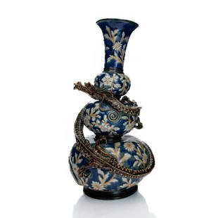 DOULTON LAMBETH FLORAL & DRAGON VASE BY MARY THOMSON: Blue ground, incised white daises, high relief scaly dragon. Artist initials MT marked to bottom base. Impressed Doulton Lambeth 1879 to base. Artist: Mary Ann Thomson Issued: 1879 Dimensions: 15"H Ma