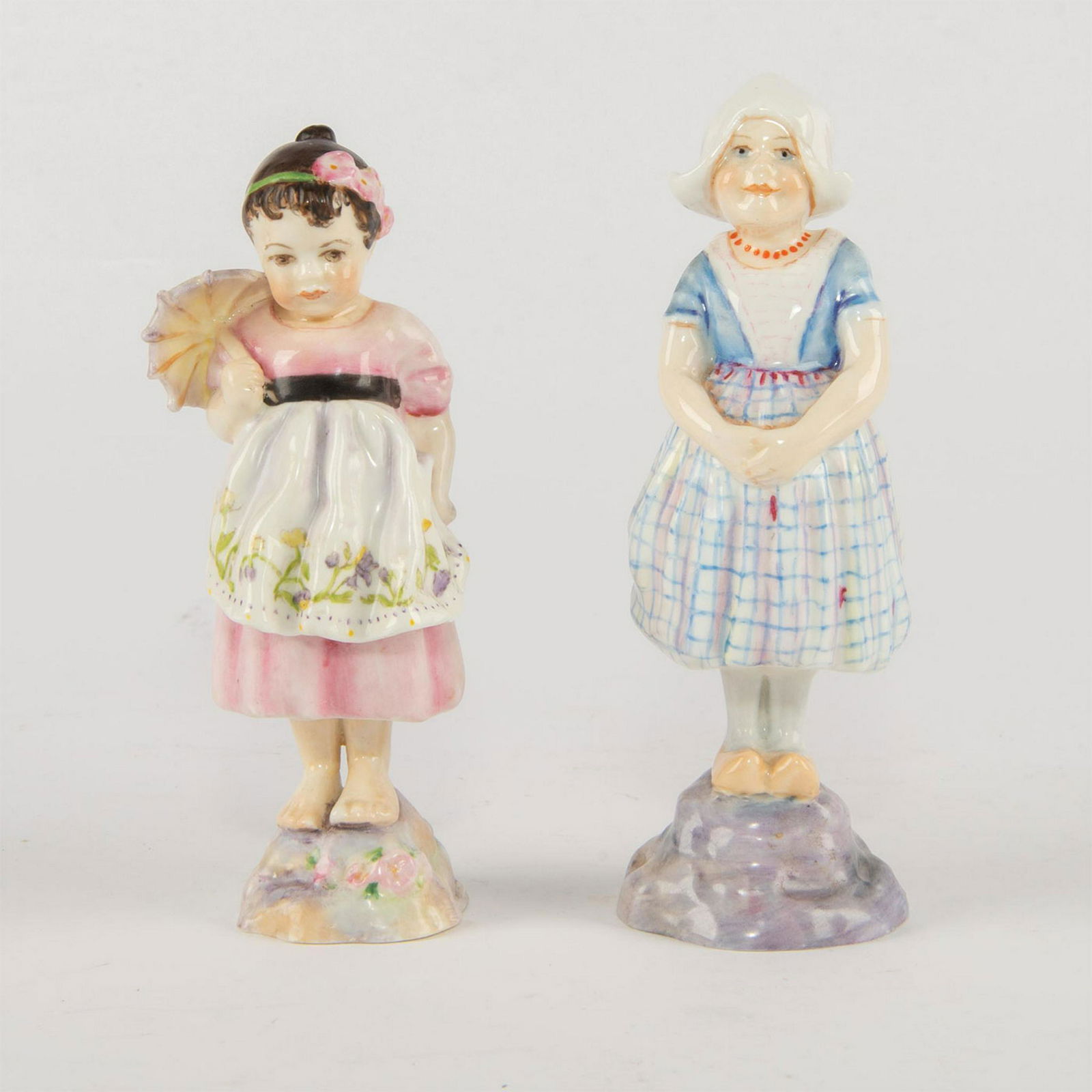 2 ROYAL WORCESTER FIGURINES, CHILDREN OF THE NATIONS: Handpainted, includes Spain RW3070 and Holland RW3074. Royal Worcester black backstamp. Artist: Freda Doughty Issued: 1940-159 Dimensions: 5.5"H, tallest Manufacturer: Royal Doulton Country of Origin: