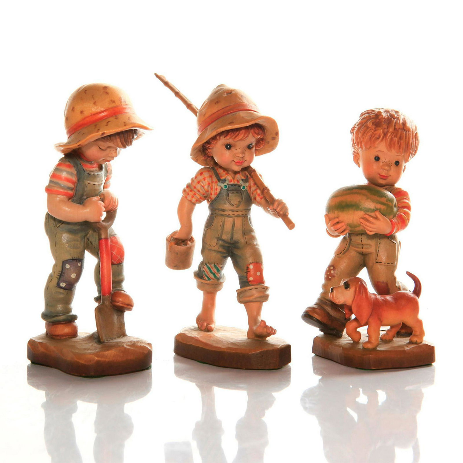 3 ANRI CARVED WOOD FIGURINES: Children, with shovel, fishing pole, watermelon. Issued: 20th c. Dimensions: 6.5"H, tallest Manufacturer: Anri Country of Origin: Italy