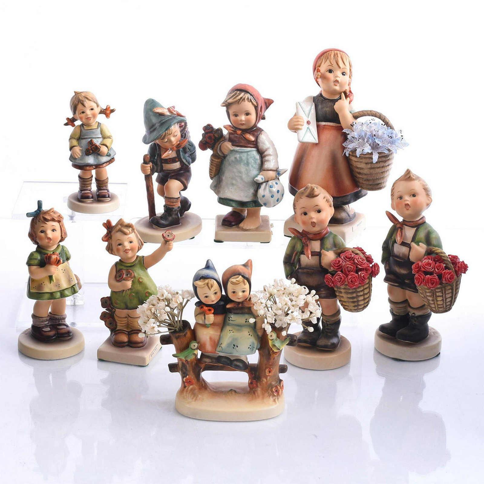 9 GOEBEL HUMMEL FIGURINES, CHILDREN & FLOWERS: Bisque porcelain children studies modeled with flora. Produced by Goebel for Hummel, the most widely collected figurines of the 20th century. Nine child studies, modeled in a variety of adorable situa