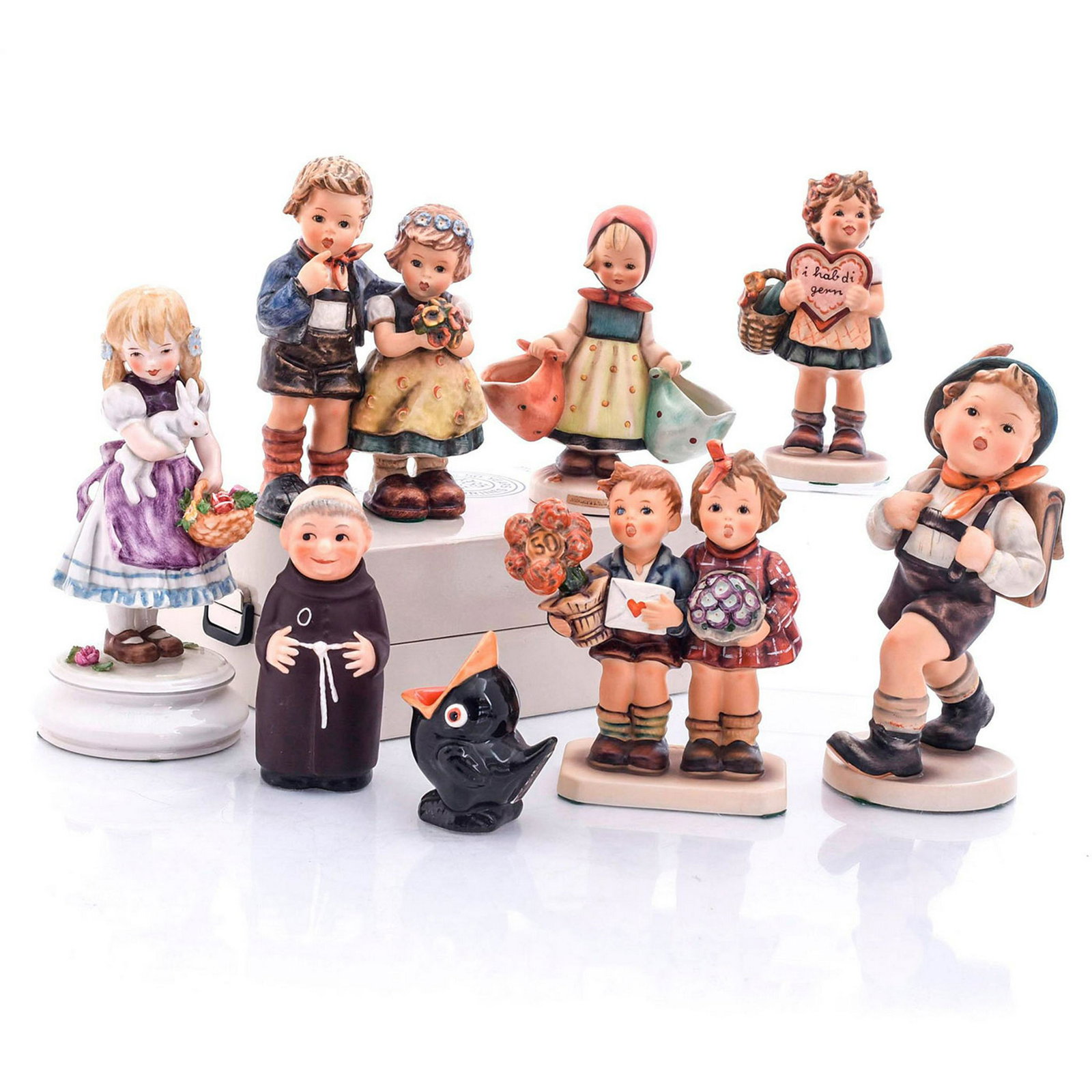 LARGE LOT OF GOEBEL FIGURINES, HUMMEL: Includes 1975 limited edition, and 50th anniversary figurine. 9 figurines. Monk has head with removable cork stopper. 50th anniversary comes with original box. Issued: 20th c. Dimensions: 8"H, tallest