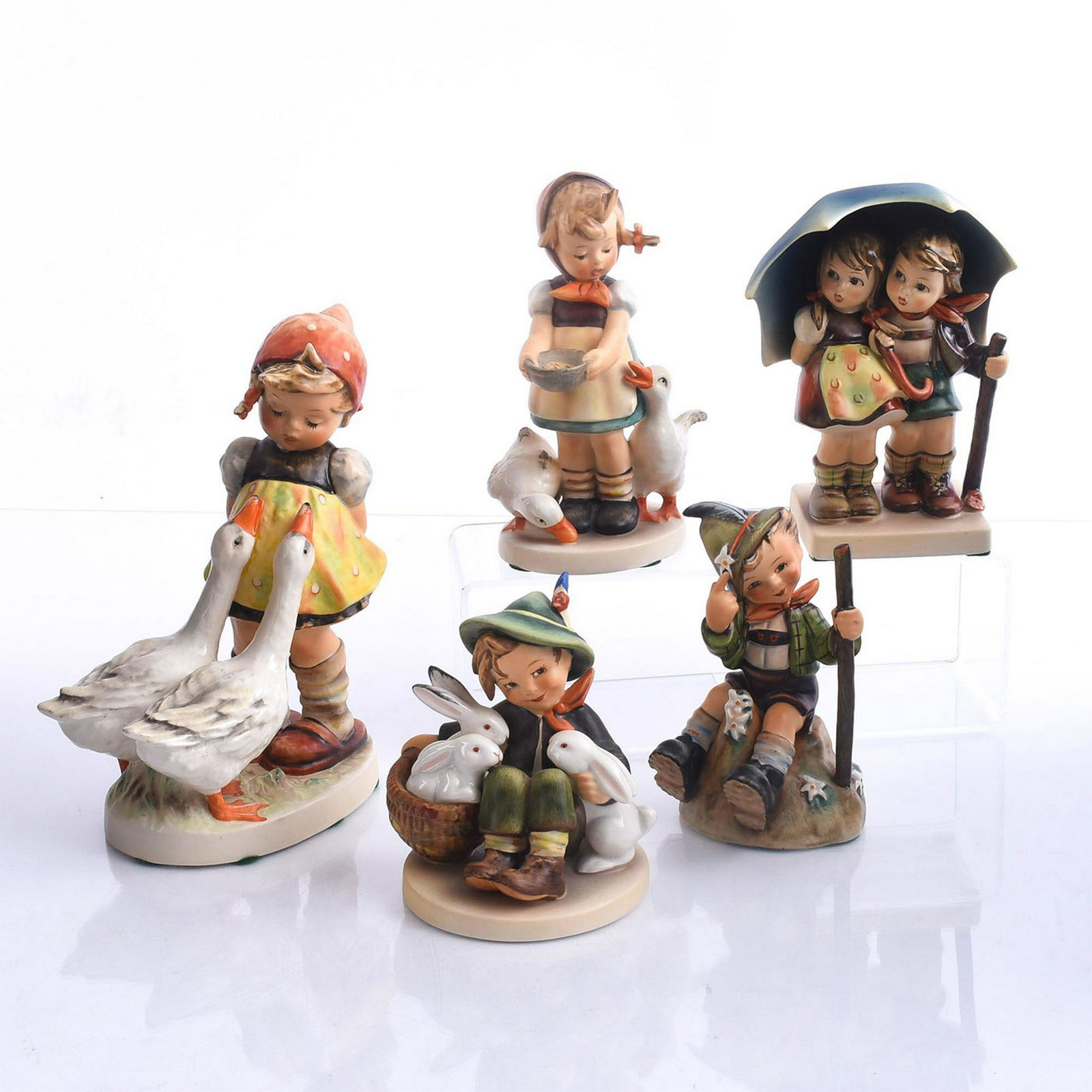 5 GOEBEL HUMMEL FIGURINES, CHILDREN & ANIMALS: Bisque porcelain children modeled with flora and animals. Produced by Goebel for Hummel, the most widely collected figurines of the 20th century. Five child studies, modeled in a variety of adorable s