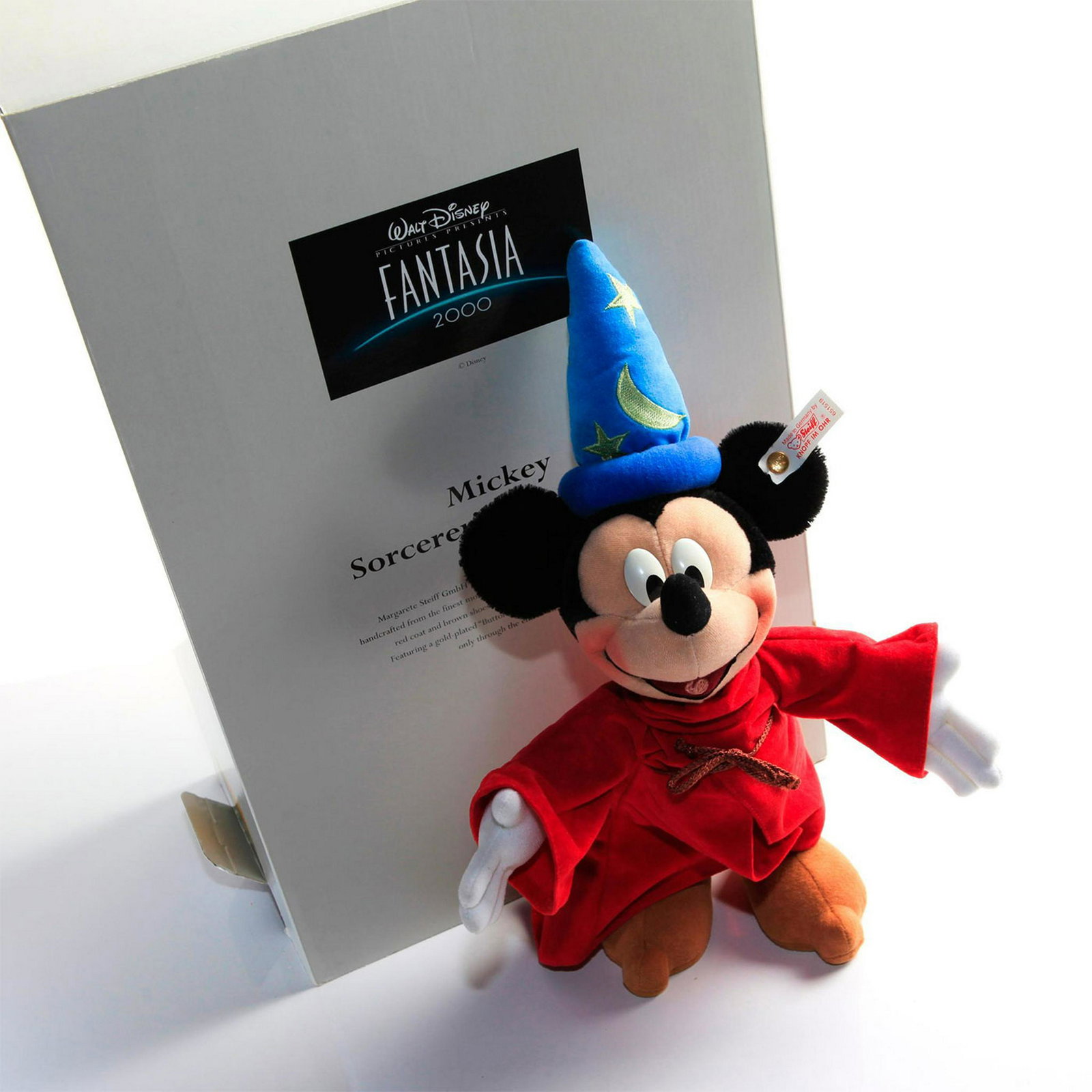 STEIFF MICKEY SORCERER'S APPRENTICE DOLL: Limited edition. Disney Fantasia 2000. Ear button and tag intact. Complete with original box. 13.5"H, Mickey. Issued: 20th c. Dimensions: 17"H x 11.25"W, box Country of Origin: Germany