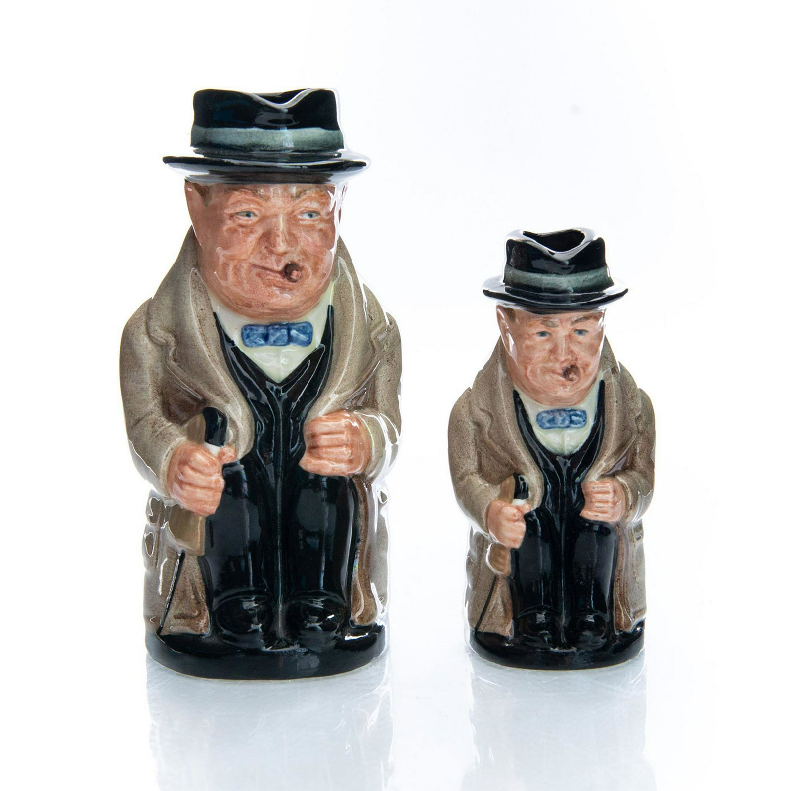 GROUP OF 2 ROYAL DOULTON TOBY JUGS, WINSTON CHURCHILL: Includes small size D6175 and medium size D6172. Marked WINSTON CHURCHILL. Royal Doulton backstamp. Artist: Harry Fenton Issued: 1941-1991 Dimensions: 5.5"H, tallest Manufacturer: Royal Doulton Countr