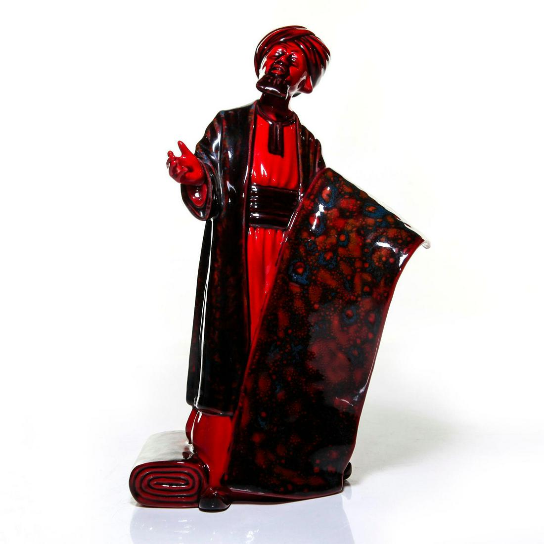 ROYAL DOULTON FLAMBE FIGURINE, THE CARPET SELLER HN2776: Fully stamped to base. Artist: William K. Harper Issued: 20th c. Dimensions: 9"H Manufacturer: Royal Doulton Country of Origin: England