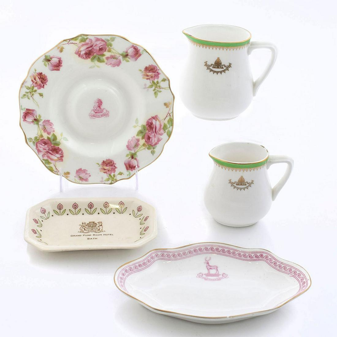 5 ROYAL DOULTON ADVERTISING CHINA HOTELWARE: 2 trays, soap dish, plate and 2 creamers. Lot includes items from the Grand Pump Room, Hyde Park, Carlton and Berkeley Hotels. One of the creamers has a chip in the rim. Issued: 20th c. Dimensions: 7"