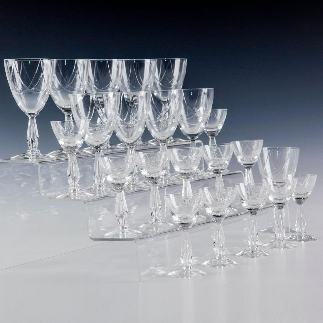 CLEAR CORDIAL AND WINE GLASSES: 22 Pieces of clear scalloped wine and cordial glasses 10 Wine glasses and 12 cordial glasses. Issued: 20th c. Dimensions: Wine 5.5"H, Cordial 4"H