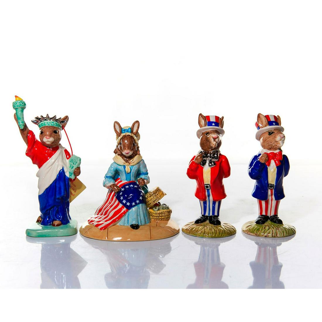 ROYAL DOULTON AMERICANA BUNNYKINS FIGURINES: A group of four featuring motifs of patriotism and U.S. History. A group of four glazed figurines: Uncle Sam DB50; Uncle Sam with silver gilt DB175; Statue of Liberty with silver gilt DB198; Betsy Ros